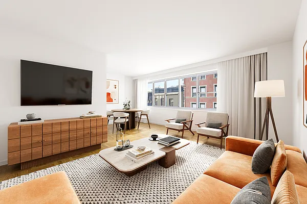 Bright modern living room with sofa, TV, and large window